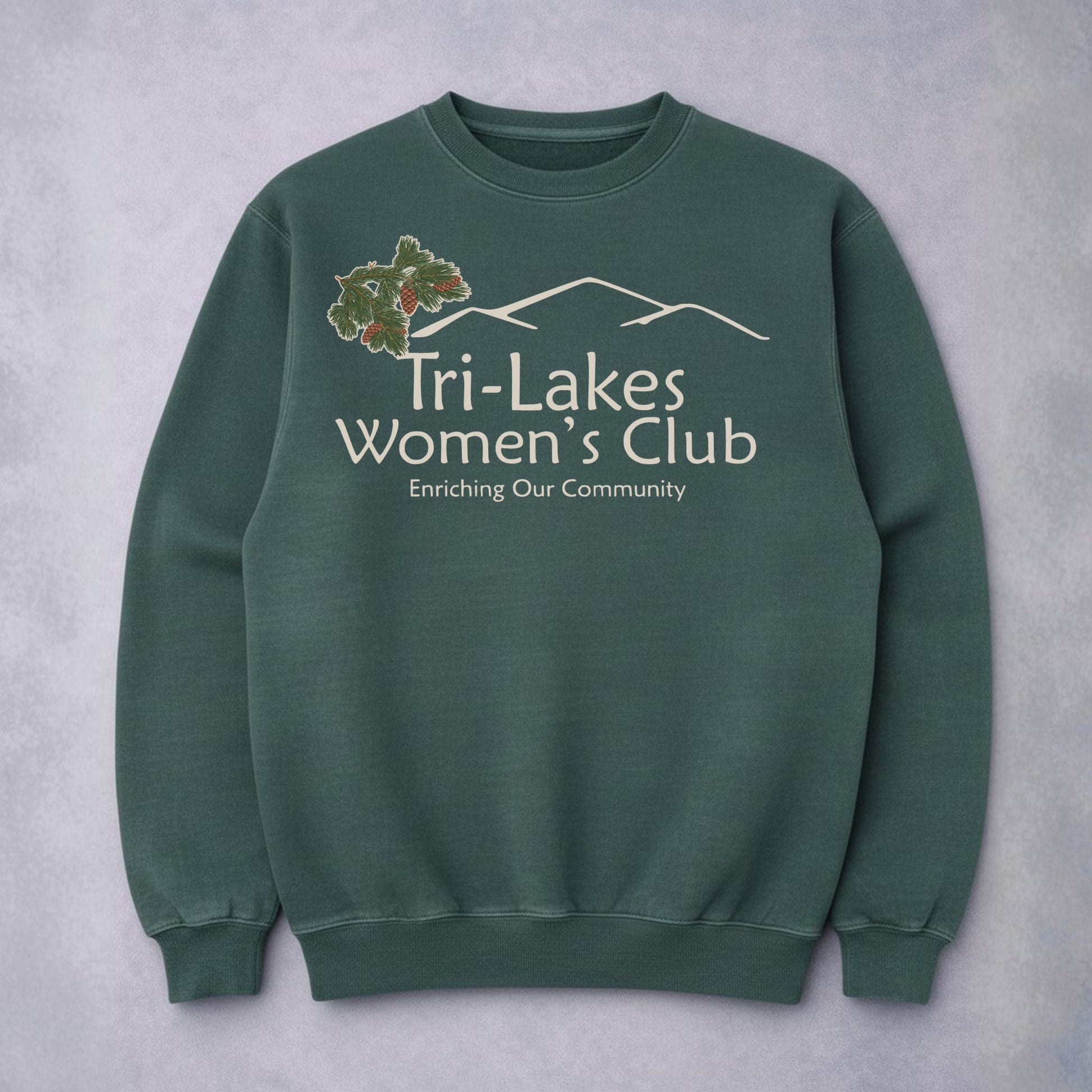 Spruce sweatshirt with 'Tri-Lakes Women's Club' text and logo on a gray background